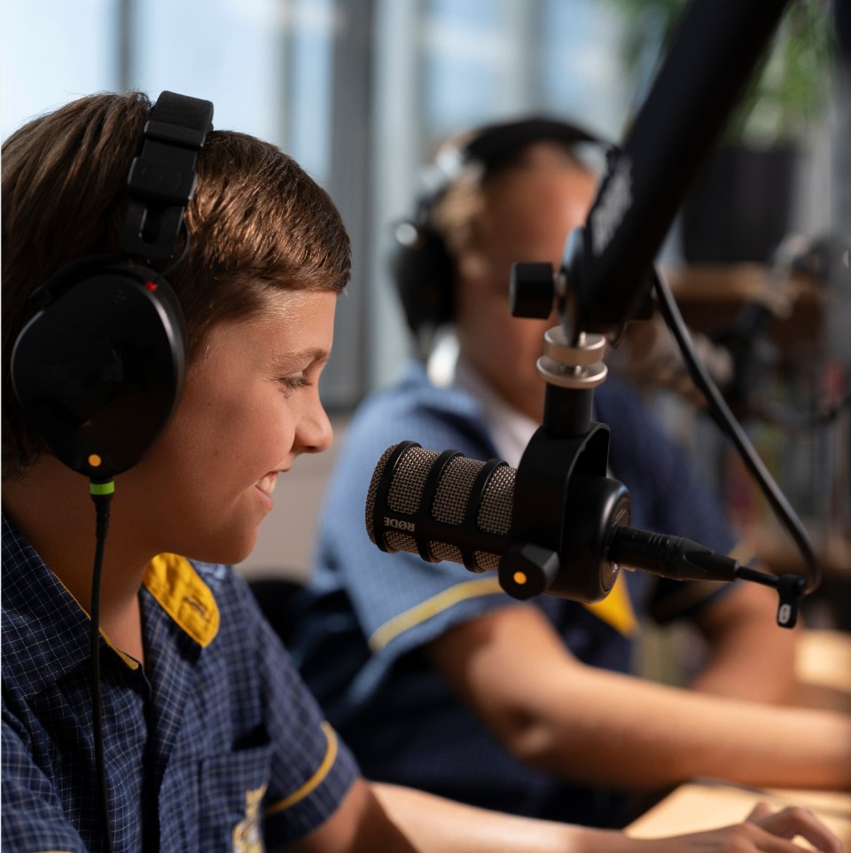 Immanuel students recording a podcast with headphones and microphones